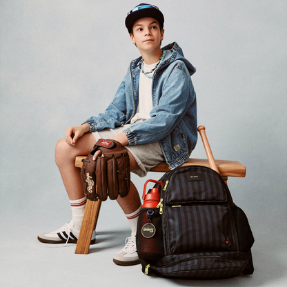 Boy sitting with STATE Bags Shea Backpack Black Gray Striped