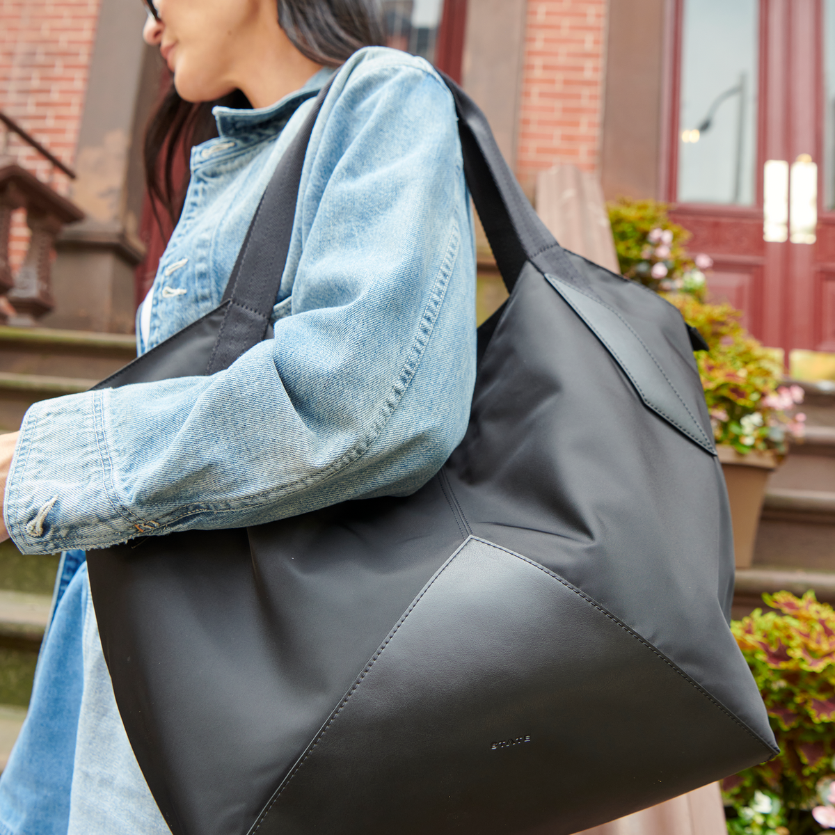 Woman wearing STATE Bags Beverly Tote Black outside