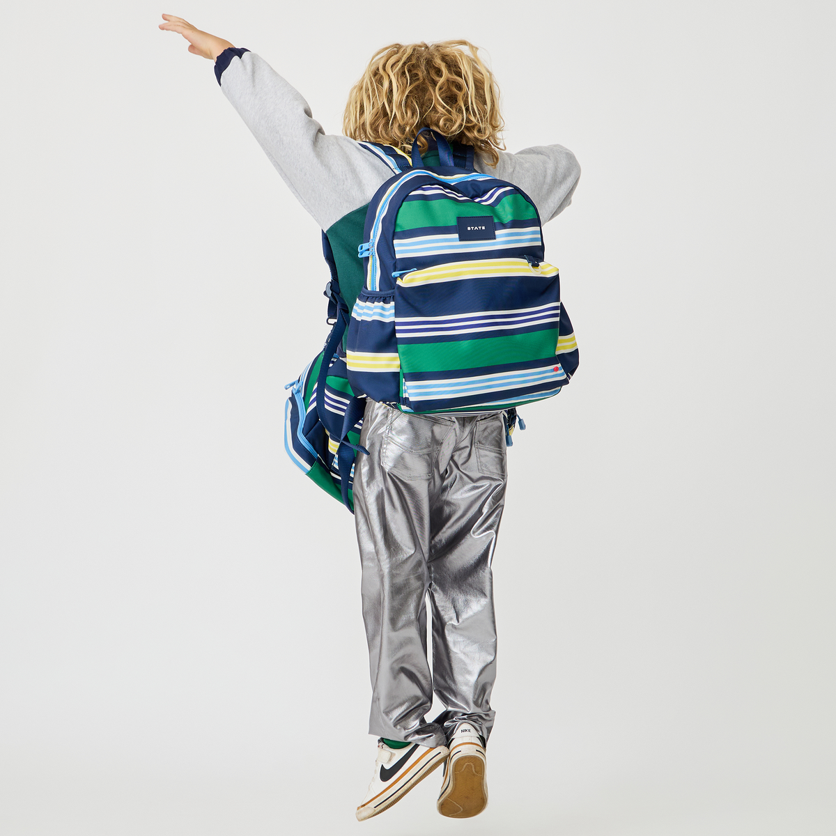 boy wearing STATE Bags Kane Backpack Polo Stripe