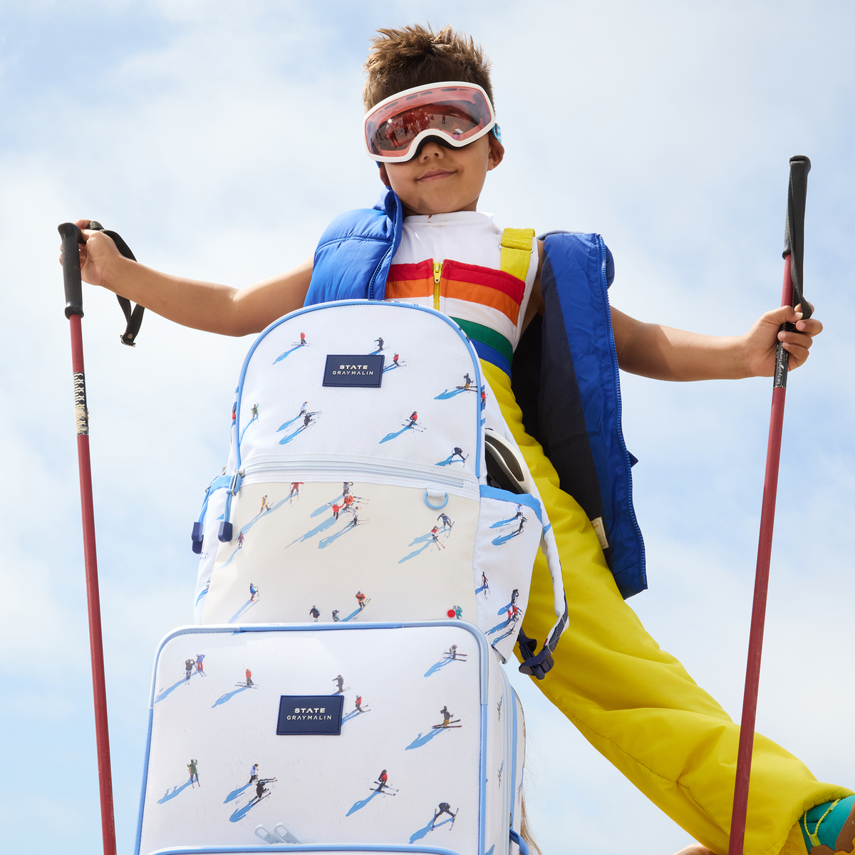 Boy wearing Kane Backpack Ski with ski poles