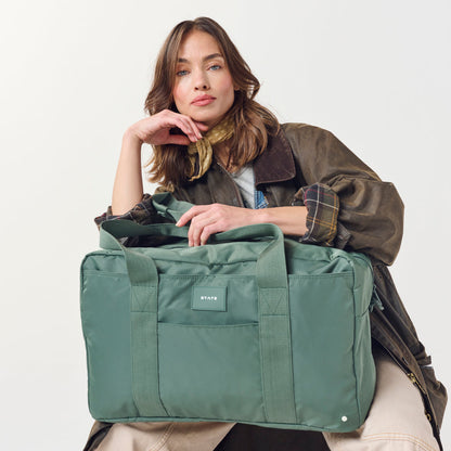 Woman holding STATE Bags Wellington Weekender Click to Zoom