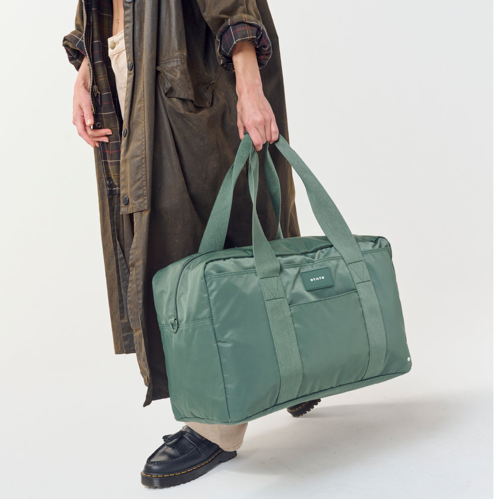 Woman carrying STATE Bags Wellington Weekender Click to Zoom
