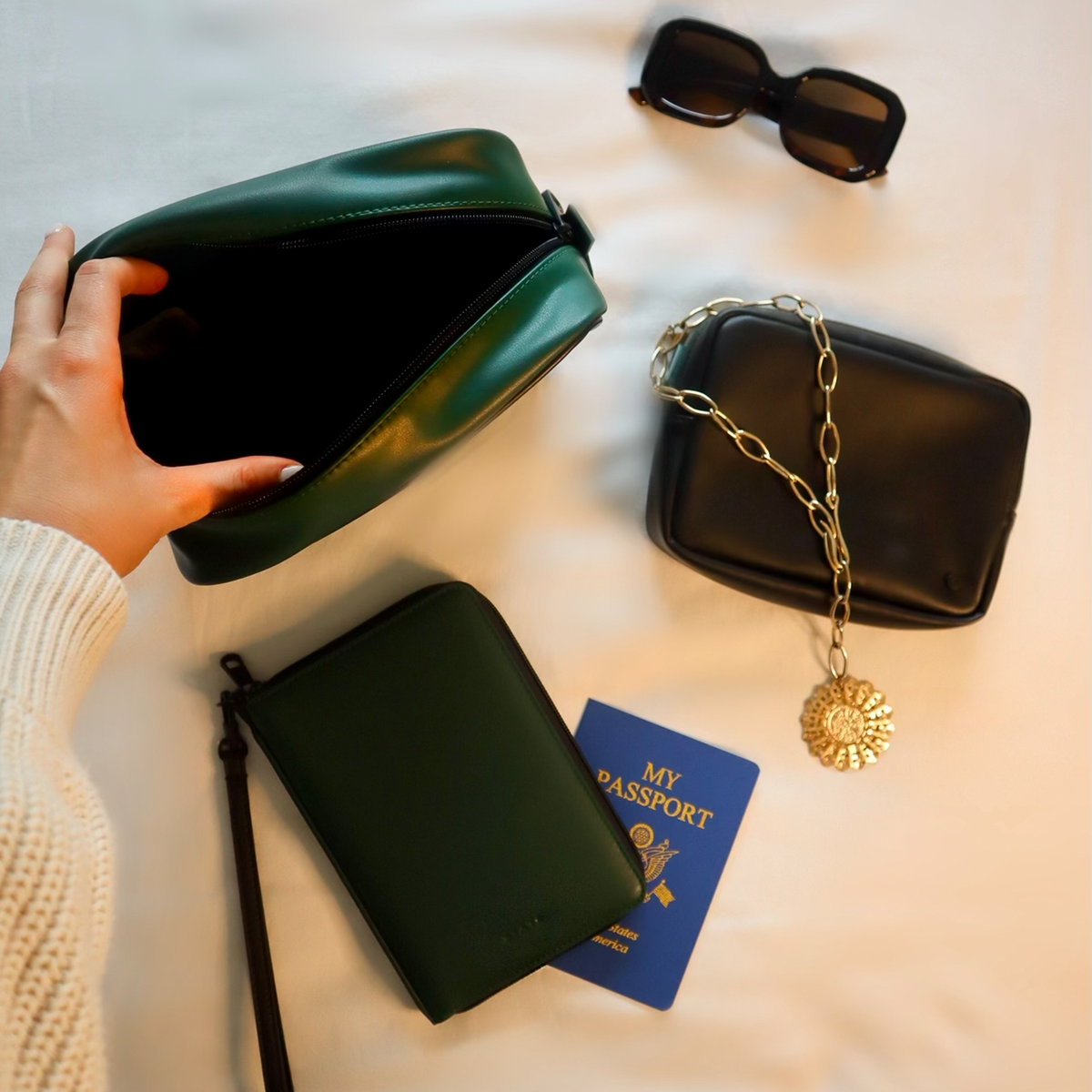 Girl opening STATE Bags Pouch in Green