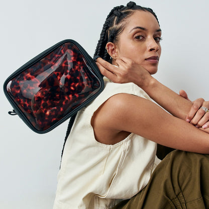 woman holding STATE Bags Travel Pouch Set of Three Tortoise